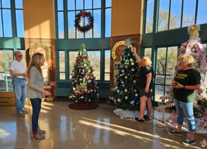 Friends of the Wells members trims a tree for Hall of Trees